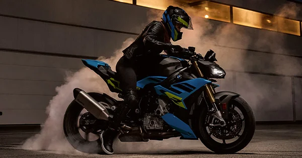 2026 BMW S 1000 R streetfighter-style motorcycle in an urban nighttime scene.